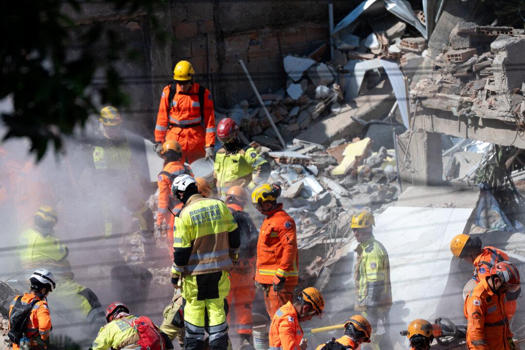 Minas Gerais' firefighters work at a collapsed nursing home in Belo Horizonte, Minas Gerais State, Brazil on March 5, 2026. The collapse of a nursing home in Belo Horizonte, southeastern Brazil, left at least four dead on March 5, 2026, while firefighters worked to search among the rubble for eight missing people, according to the latest tally. (Photo by DOUGLAS MAGNO / AFP via Getty Images)