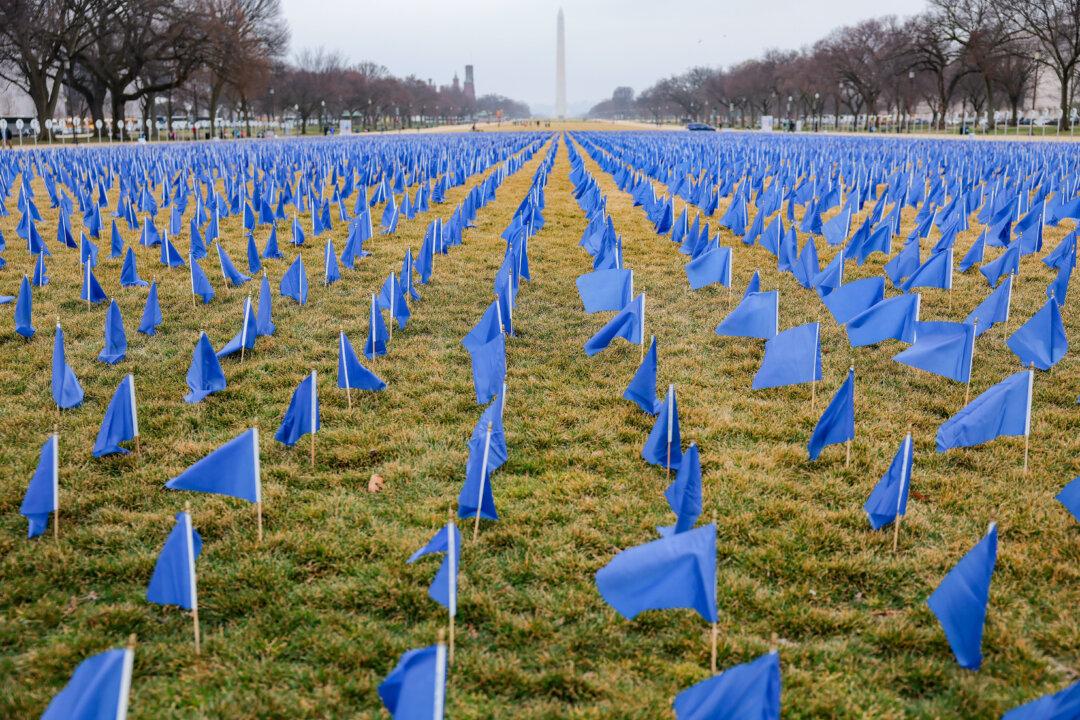 27,000 blue flags are on display at the National Mall to represent lives that could be saved from colorectal cancer with further funding and research in Washington on March 6, 2026. The installation on the National Mall encourages Congress to dedicate more funding towards research on colorectal cancer. (Heather Diehl/Getty Images)