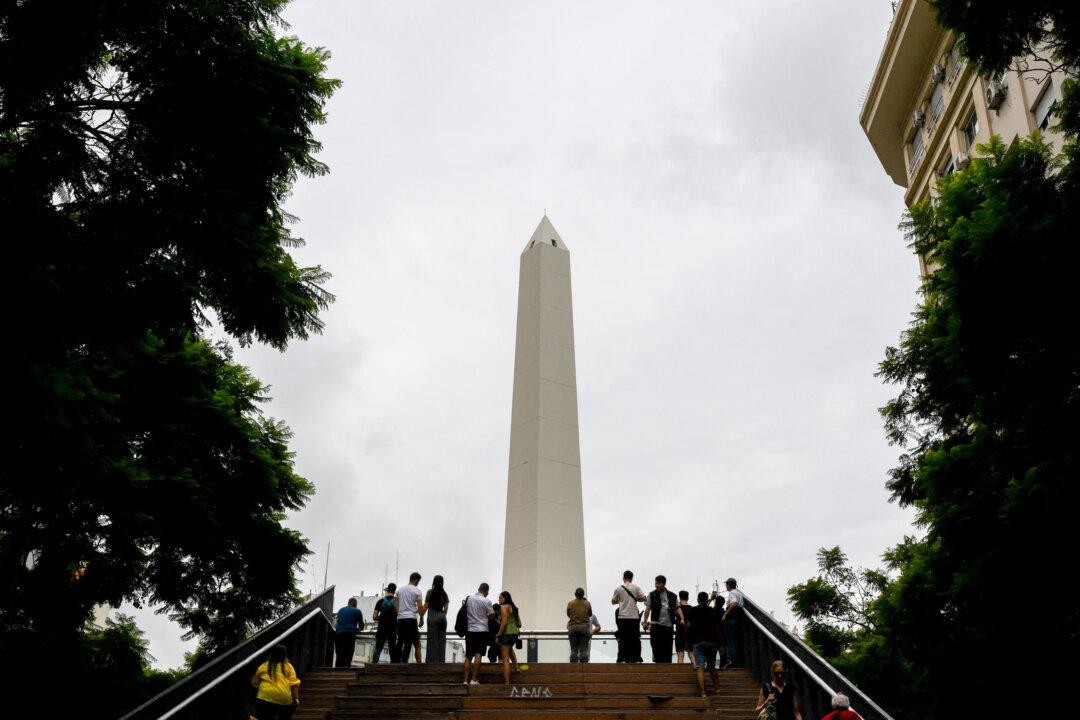 Tourists look the Obelisk in Buenos Aires, Argentina, on March 6, 2026. (Luis Robayo / AFP via Getty Images)