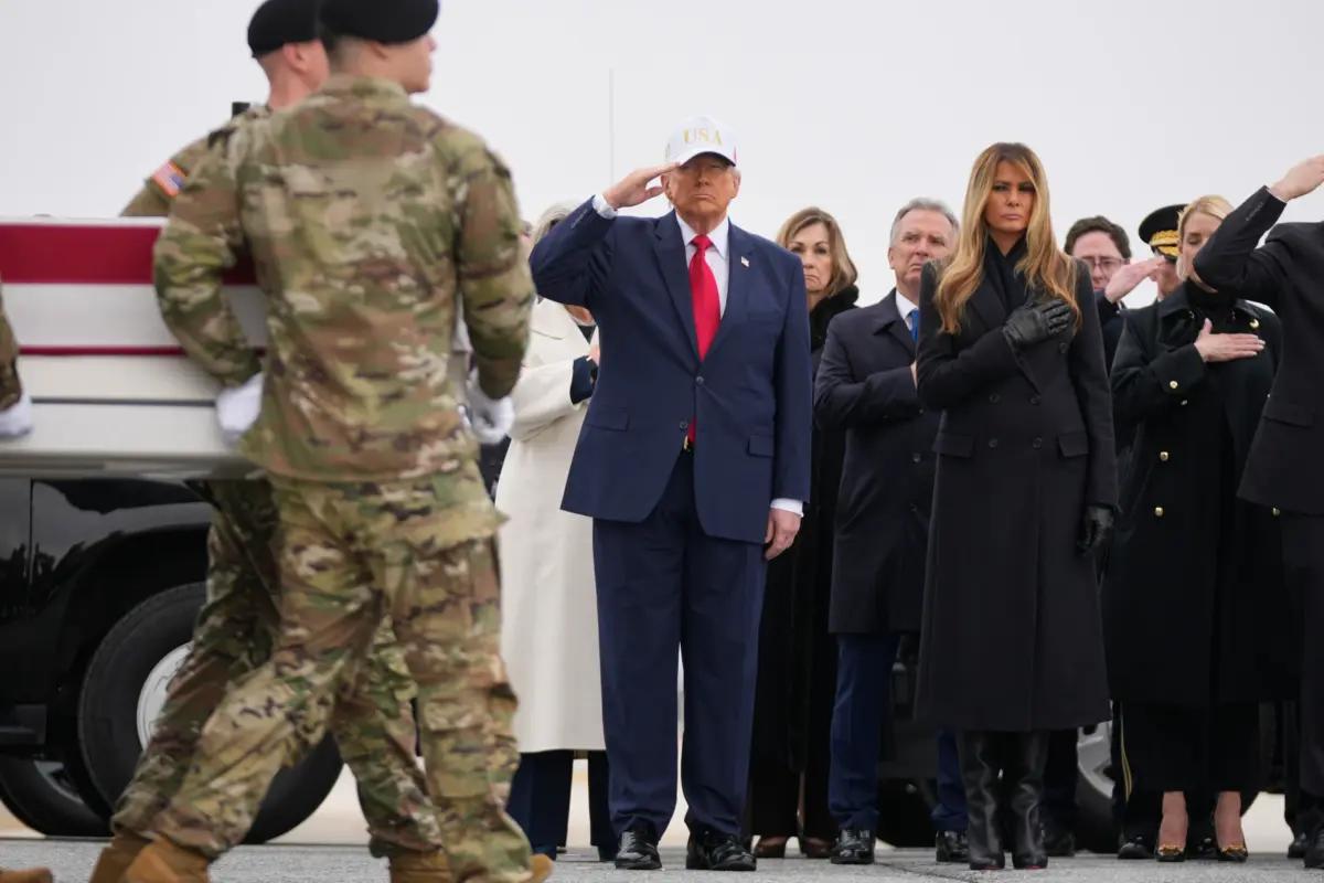 An Army carry team moves a flag-draped transfer case with the remains of U.S. Army Reserve soldier Sgt. First Class Nicole Amor, of White Bear Lake, Minn., past President Donald Trump and First Lady Melania Trump during a casualty return, at Dover Air Force Base, Del., on March 7, 2026. (Mark Schiefelbein/AP Photo)