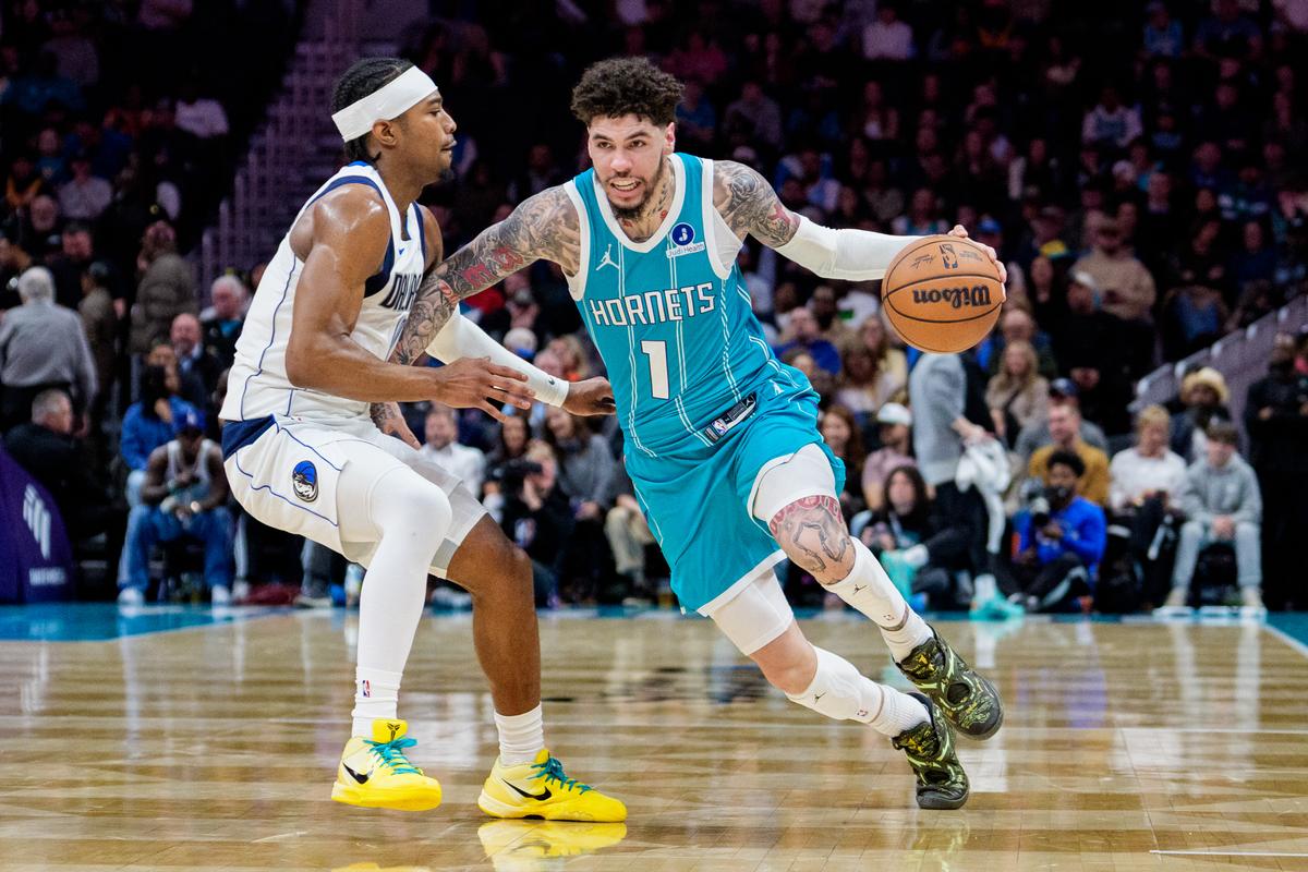 LaMelo Ball of the Charlotte Hornets brings the ball up court while guarded by Brandon Williams of the Dallas Mavericks in the first half during their game at Spectrum Center in Charlotte, N.C., on March 3, 2026. (Jacob Kupferman/Getty Images)