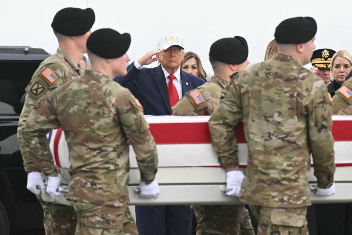 President Donald Trump salutes as members of a U.S. Army team carry a flag-draped transfer case containing the remains of Sgt. 1st Class Noah L. Tietjens during a dignified transfer solemn event at Dover Air Force Base, in Dover, Del., on March 7, 2026. (Saul Loeb/AFP via Getty Images)