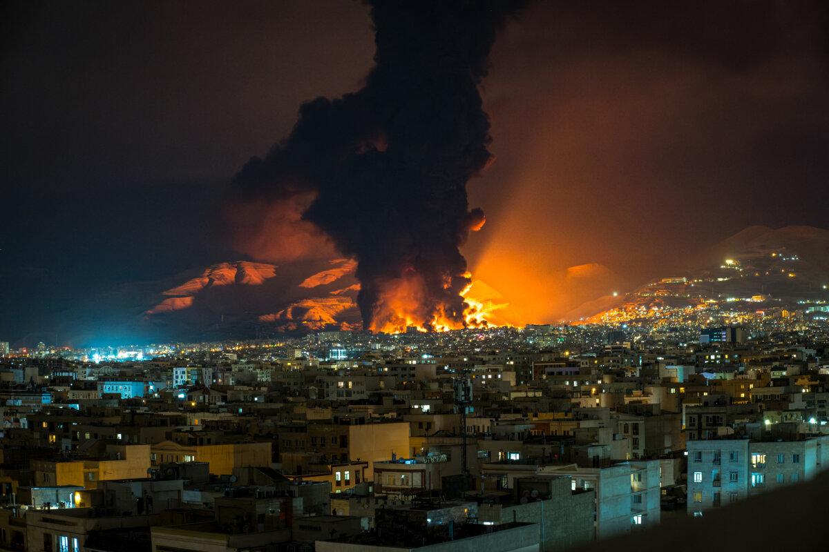 Smoke and flames rise at the site of airstrikes on an oil depot in Tehran on March 7, 2026. (Sasan/Middle East Images/AFP via Getty Images)
