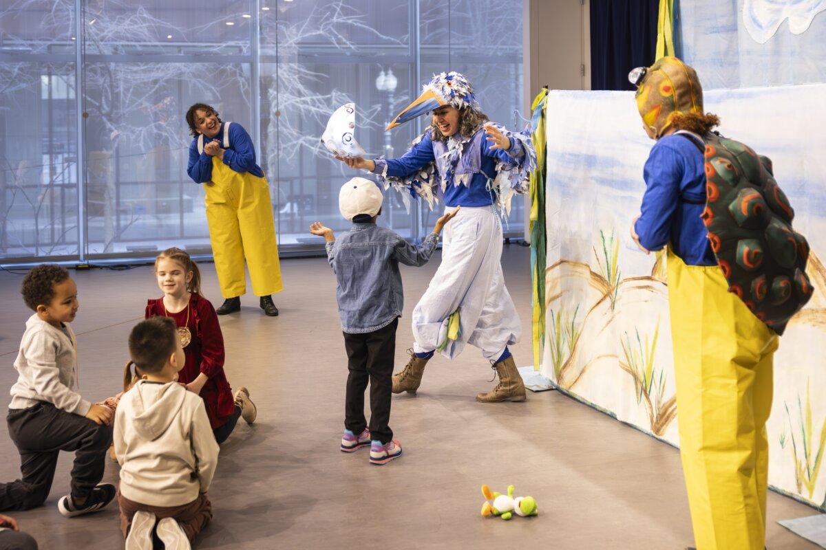 Young audience members interact with performers during the immersive production “Splish Splash: A Day on the Lake” at Goodman Theatre’s Alice Center. (Boris Martin)