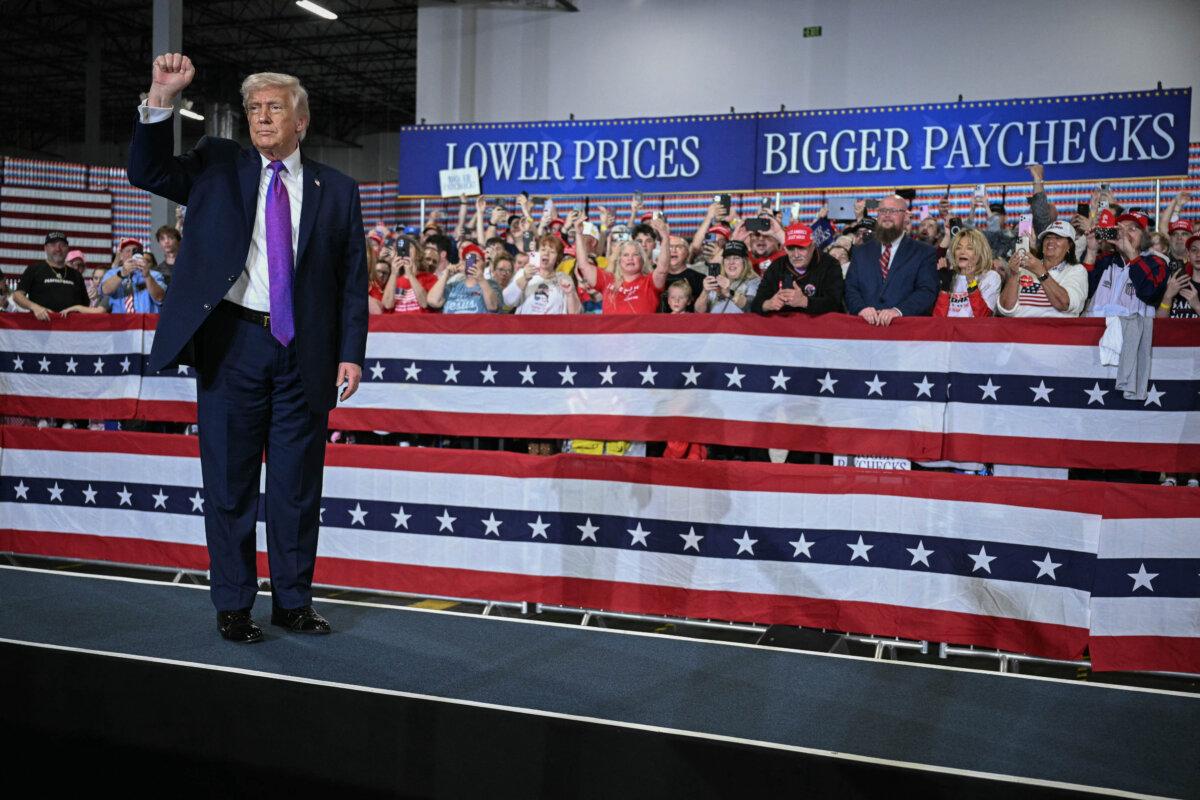 U.S. President Donald Trump pumps his fist after speaking at Verst Logistics in Hebron, Kentucky, on March 11, 2026. (Jim Watson/AFP via Getty Images)