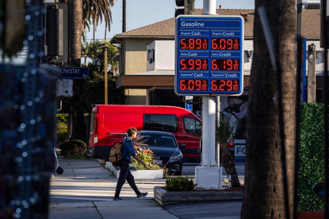 A man walks past a gas station in Los Angeles on March 11, 2026. (John Fredricks/The Epoch Times)