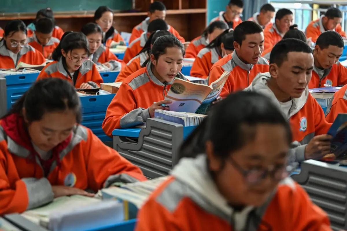 This photograph, taken during a regime-organized media tour, shows students in a classroom at the Lhasa Nagqu Second Senior High School in the regional capital Lhasa, Tibet, on June 1, 2021. (Hector Retamal/AFP via Getty Images)