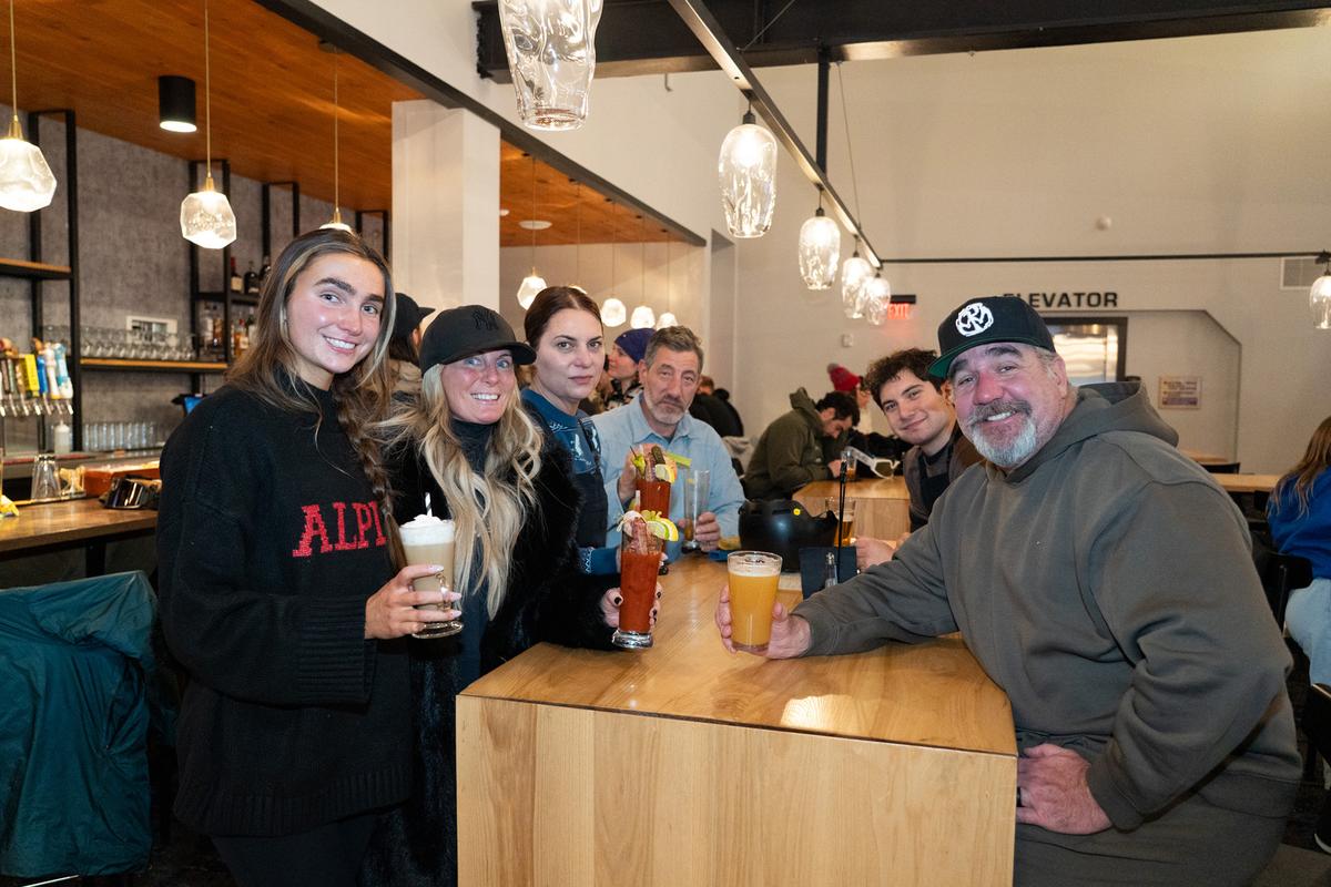 A family enjoys drinks before their dinner at Iron Loft, on the upper level of the Carinthia base at Mount Snow, Vt. Menu favorites include truffle fries, Brussels sprouts confit, burrata plate, brisket and short rib French dip, ribeye, skillet-baked cookie, handcrafted cocktails, and Vermont's famed IPA beers. (Brooke Cerbone/Vail Resorts)