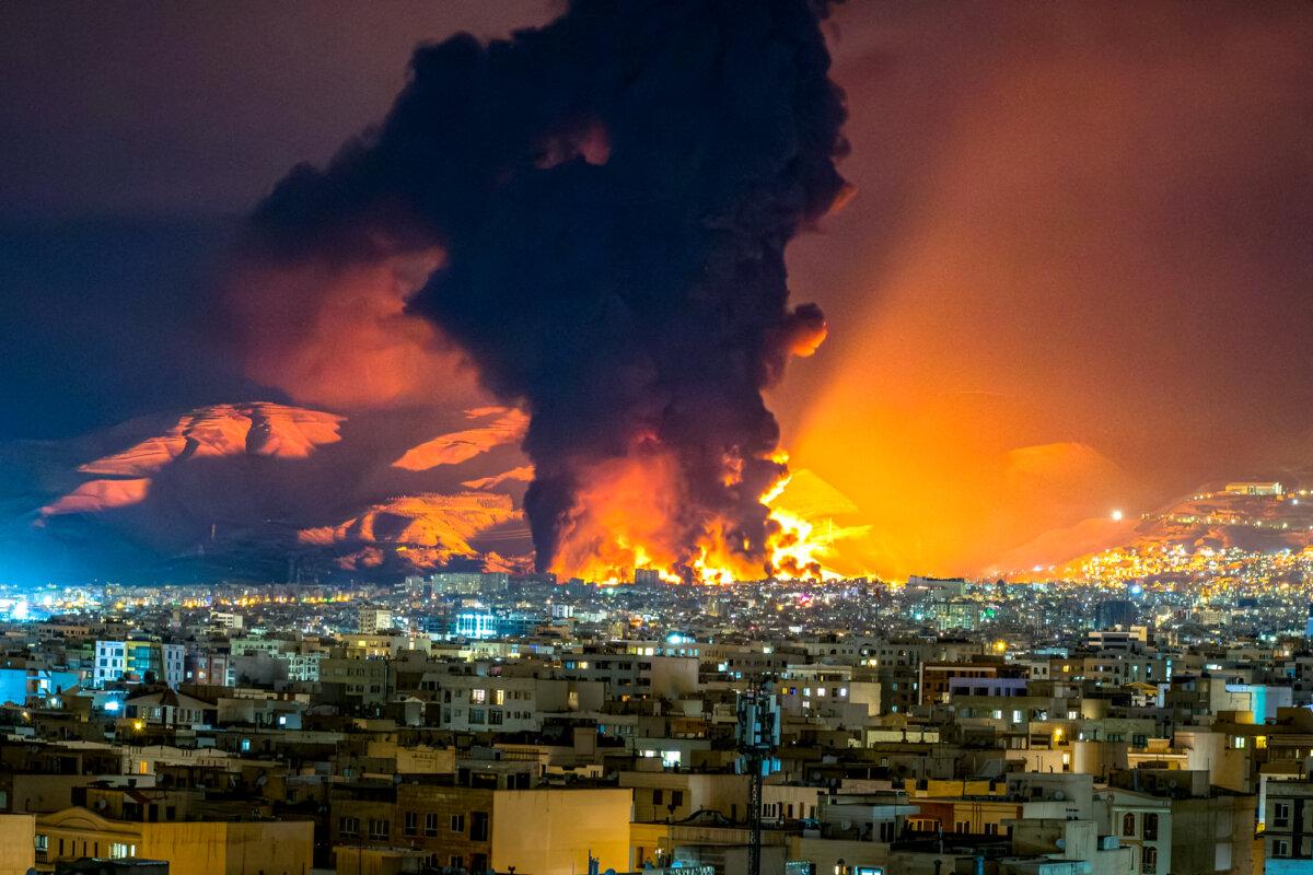 Smoke and flames rise at the site of airstrikes on an oil depot in Tehran on March 7, 2026. (Sasan / Middle East Images / AFP via Getty Images)