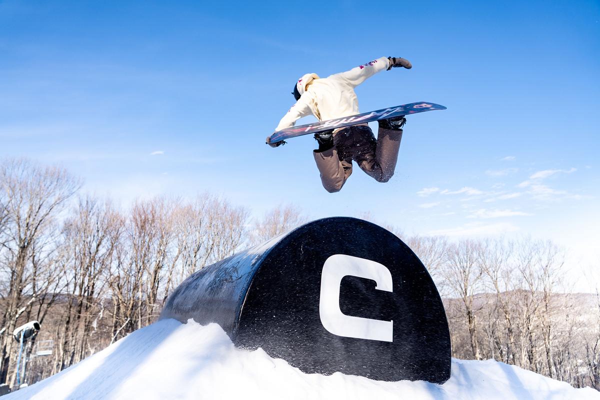 A rider launches a backside grab over a feature at Mount Snow’s Carinthia freestyle feature park. Carinthia is often regarded as the most complete park of its kind in the eastern United States. It has more than 100 features, a fully dedicated area of the mountain for freestyle, with a progression from beginner to professional level of difficulty, along with a renovated base area with fire pits and Adirondack chairs. (Brooke Cerbone/Vail Resorts)