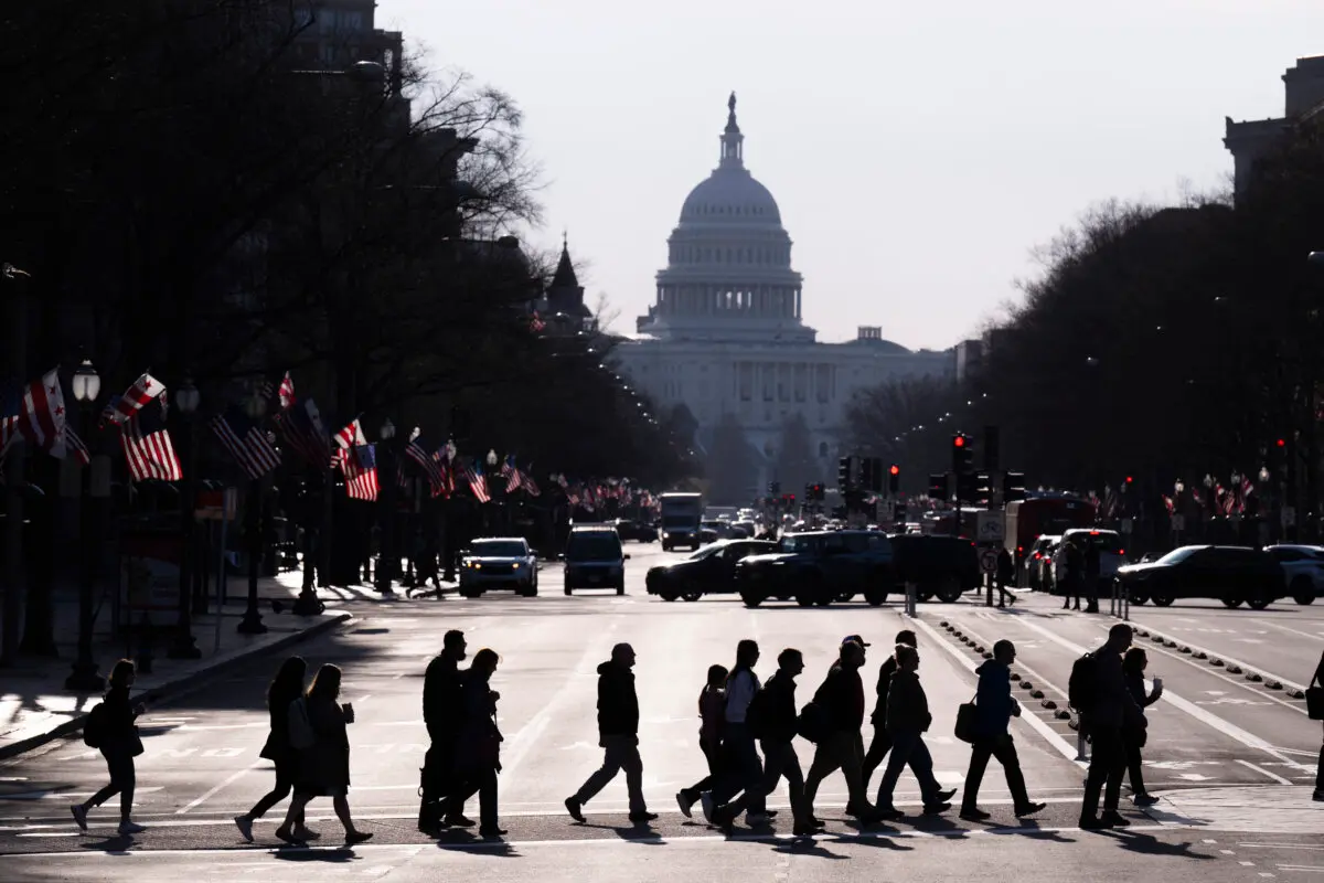 Commuters cross Pennsylvania Avenue in downtown Washington during the morning rush hour on March 20, 2025. (Roberto Schmidt/AFP via Getty Images)