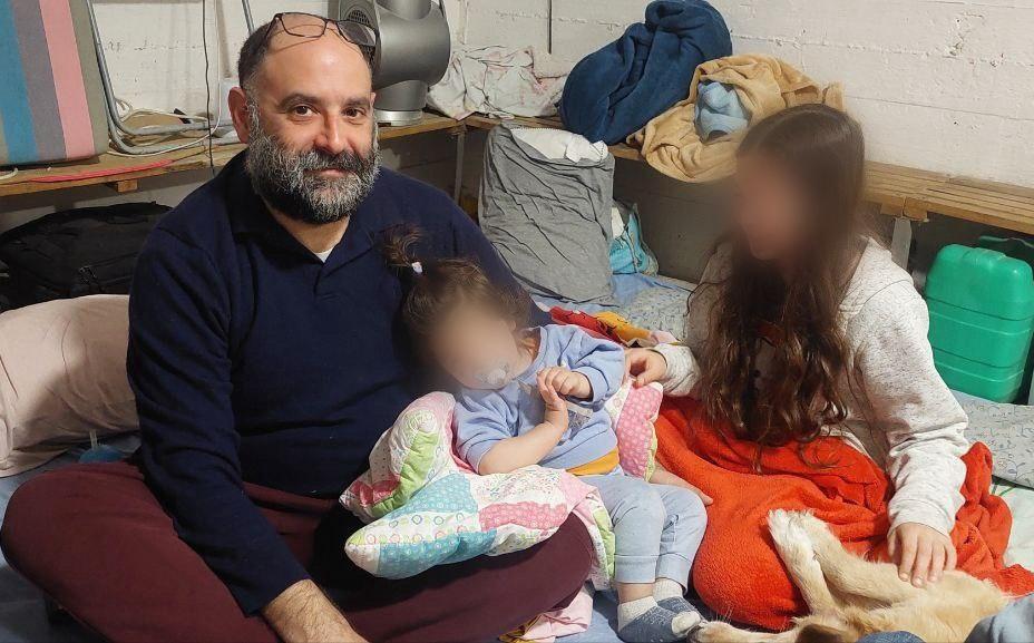 Eitan and his children wait out a missile attack from Iran in an Israeli shelter. (This image was digitally altered to conceal children's identities.) (Rachel Berestetsky)