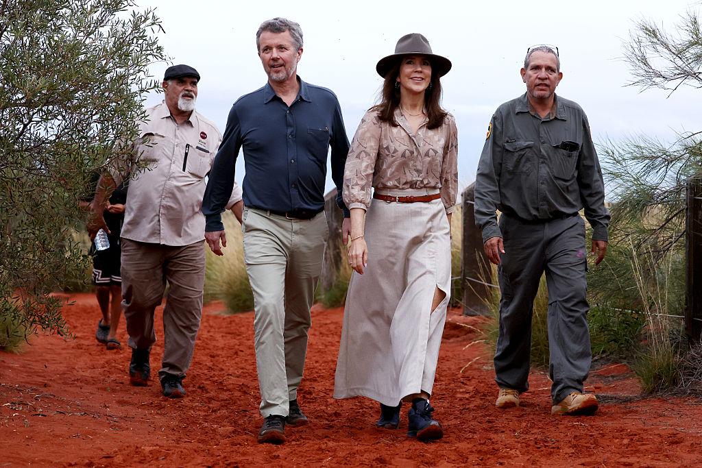 Denmark's King Federik X (2/L) and Queen Mary (2/R) are escorted park rangers to view Uluru, also known as Ayers Rock and and is a large sandstone monoliton in the Australian outback at Uluru during their five-day state visit to Australia, on March 14, 2026. (David Gray - Pool/Getty Images)