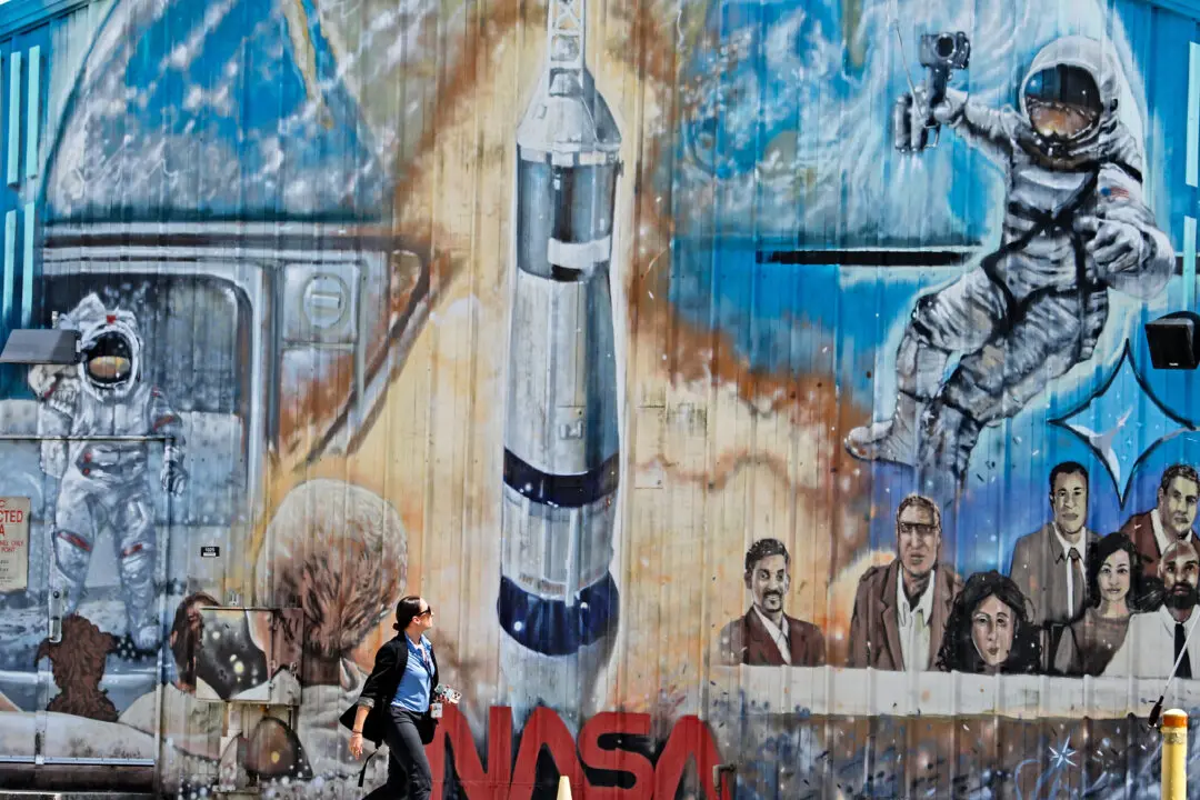 A journalist arrives for a press briefing to update the progress on the Artemis II crewed mission around the Moon at the Kennedy Space Center in Cape Canaveral, Fla., on March 12, 2026. NASA rolled the massive Space Launch System rocket and Orion spacecraft back to the Vehicle Assembly Building from Launch Pad 39B on February 25 to troublshoot problems encountered during a wet dress rehearsal. NASA engineers and technicians will effect repairs and replace numerous flight batteries prior to sending four astronauts to the moon for the first time in more than 50 years. Artemis II is scheduled to launch in April. (Gregg Newton / AFP via Getty Images)