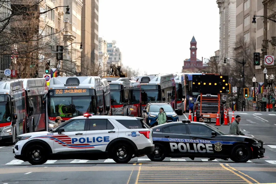 Members of DC Metropolitan Police respond to reports of a bomb threat near One Franklin Square in Washington on March 13, 2026. According to reports, police were able to clear the area without incident. (Kevin Dietsch/Getty Images)