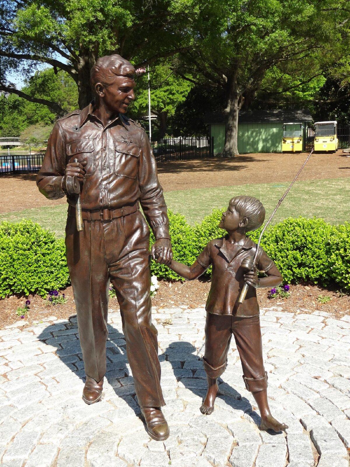 The sculpture of Andy Griffith and a young Ron Howard by Stuart Williamson welcomes visitors to Mount Airy, N.C. (Kelley Albert/Dreamstime)