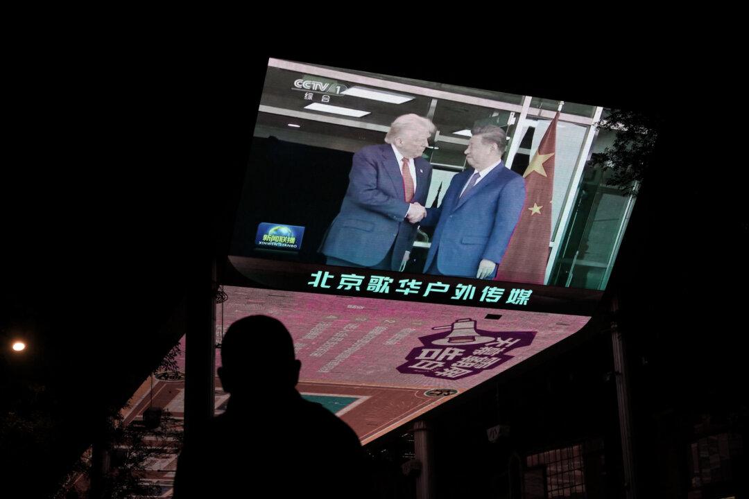 News coverage of the meeting between U.S. President Donald Trump and Chinese leader Xi Jinping in South Korea is shown on a television outside a shopping mall in Beijing on Oct. 30, 2025. (Adek Berry/AFP via Getty Images)
