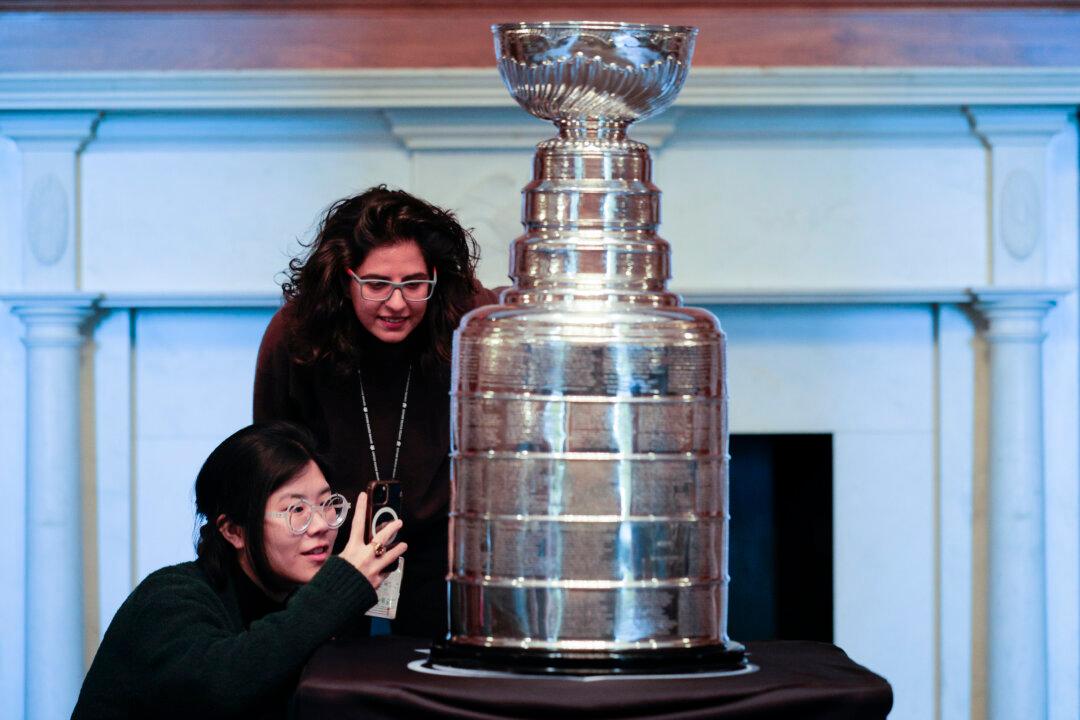 WASHINGTON, DC - MARCH 17: U.S. Senate staff members Priscilla Kim and Mana Azarmi take a close look at The Stanley Cup, the National Hockey League's championship trophy, in the Mansfield Room at the U.S. Capitol on March 17, 2026 in Washington, DC. The trophy is touring Capitol Hill at the invitation of Sen. Rick Scott (R-FL) after the Florida Panthers won the championship in 2025. (Photo by Chip Somodevilla/Getty Images)