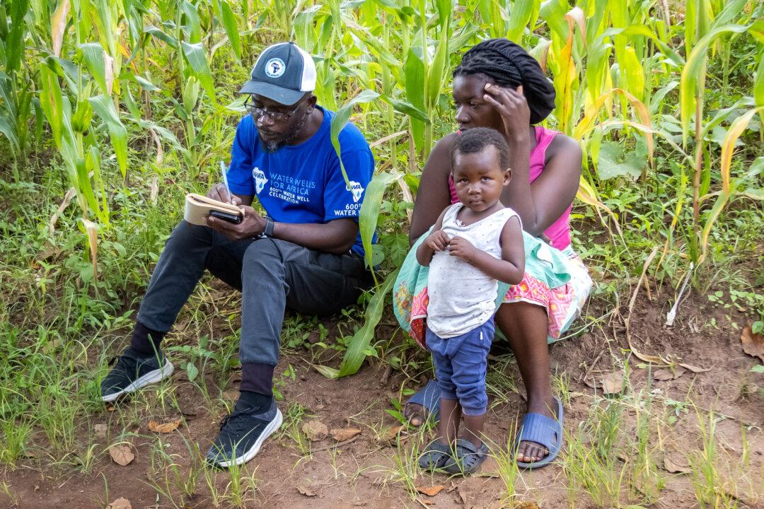 Water Wells for Africa Operations Officer Fexton Manja gathers information during a water well site inspection near the Thyolo district, Malawi, on Feb. 24, 2026. For the nonprofit organization, installing water wells in Malawi’s most hard-to-reach locations has been the core of its operational mission for more than three decades. (John Fredricks/The Epoch Times)