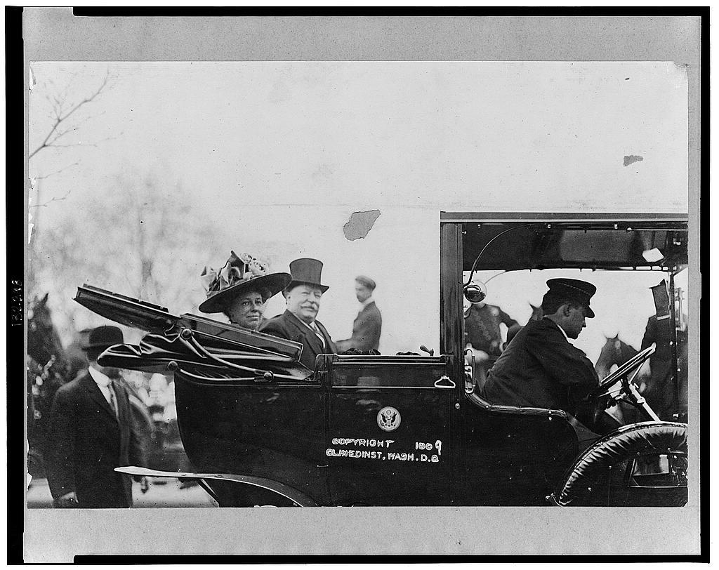 President William Howard Taft and Mrs. Taft seated in the back of a convertible automobile with the roof down, in 1909. Library of Congress. (Public Domain)