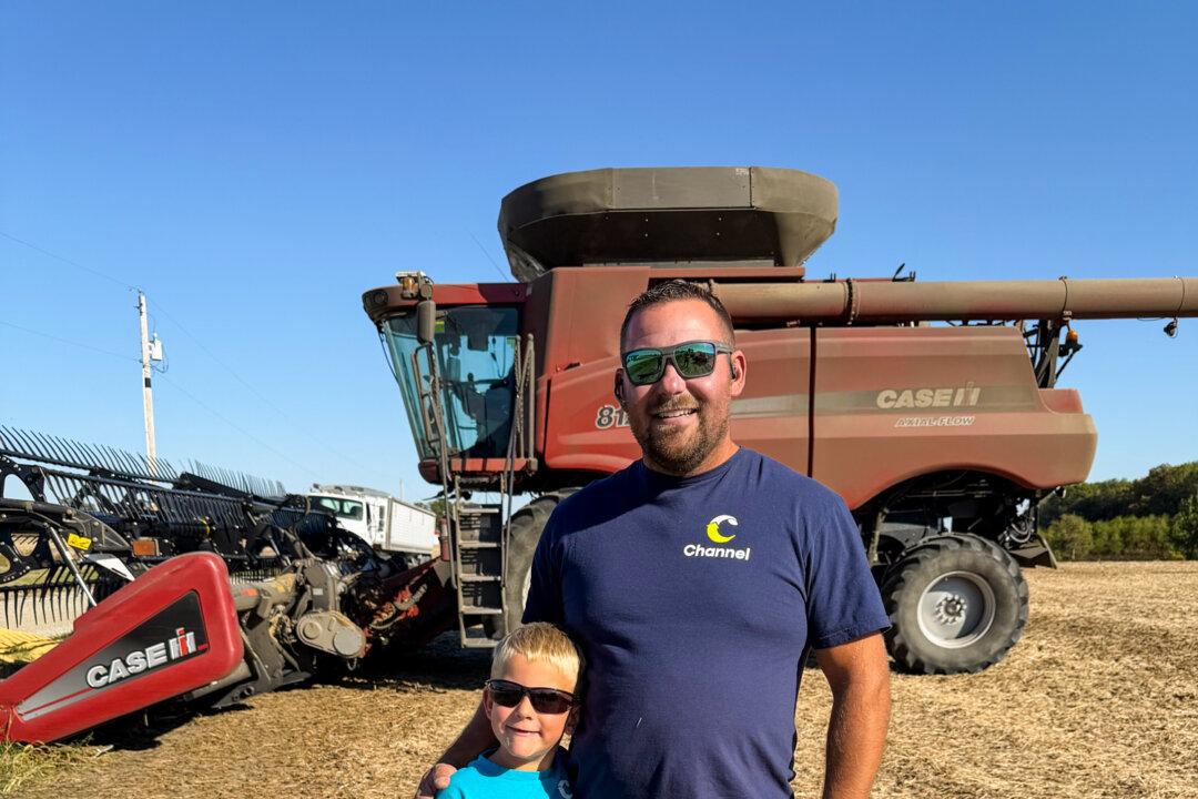 CJ Chalfant stands with his son at Double Ridge Farms in Hartford City, Ind., on Oct. 11, 2025. (Courtesy of CJ Chalfant)