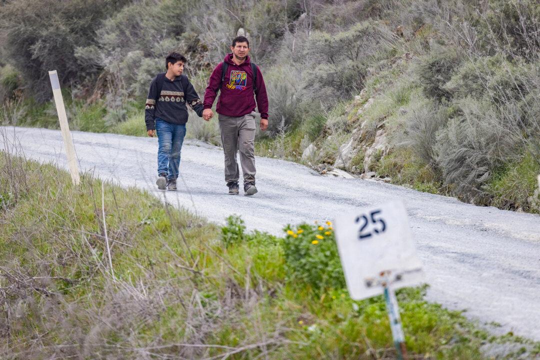(Top) A former migrant encampment known as “Moon Camp” now sits empty of illegal immigrants in Jacumba Hot Springs, Calif., on Jan. 22, 2026. (Bottom Left) Construction on the United States Southern border wall is seen from Otay Mesa, Calif., on Jan. 21, 2026. (Bottom Right) Illegal immigrants walk toward a Border Patrol checkpoint on Otay Mountain east of San Diego on Feb. 29, 2024. (John Fredricks/The Epoch Times)