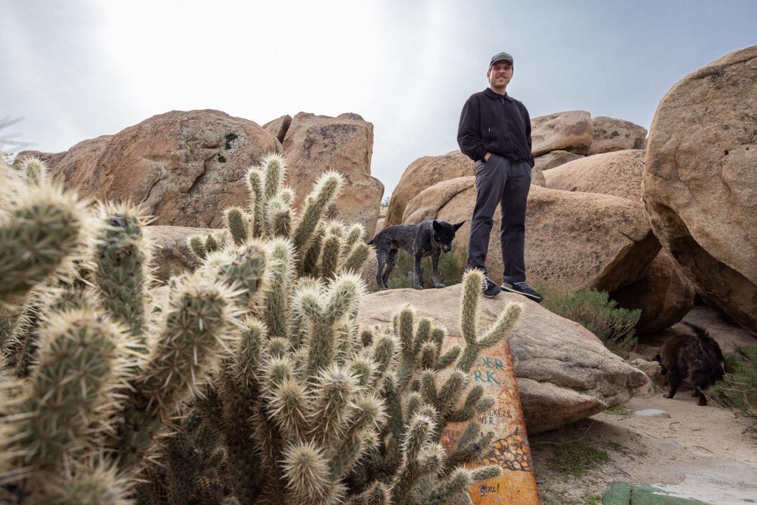 John Schultz stands with his dogs near his home in Jacumba, Calif., on Jan. 21, 2026. Shultz and his family and friends provided hot meals and sandwiches to illegal immigrants during the border crisis, when hundreds were crossing daily at Jacumba. (John Fredricks/The Epoch Times)