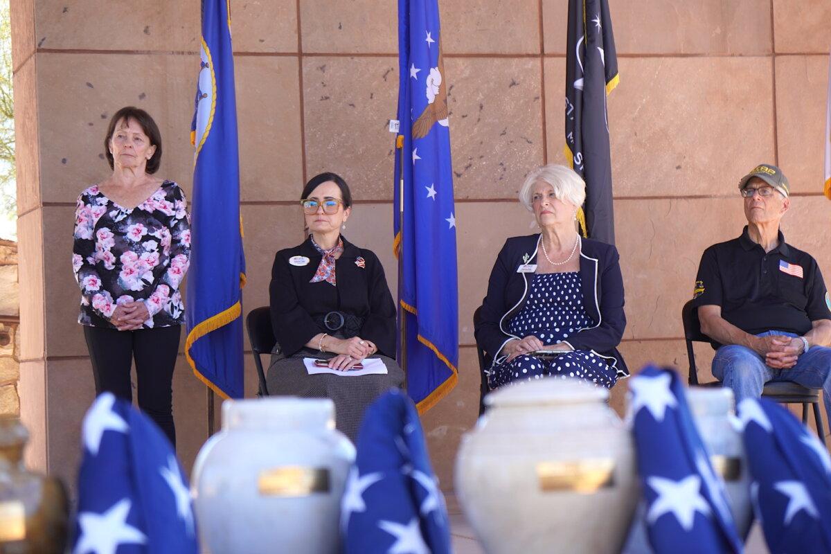 Patricia Palermo (L), Arizona Assistant State Coordinator for the Missing In America Project, stands with other volunteers during a funeral service for 14 veterans and a spouse in Phoenix on March 18, 2026. (Allan Stein/The Epoch Times)