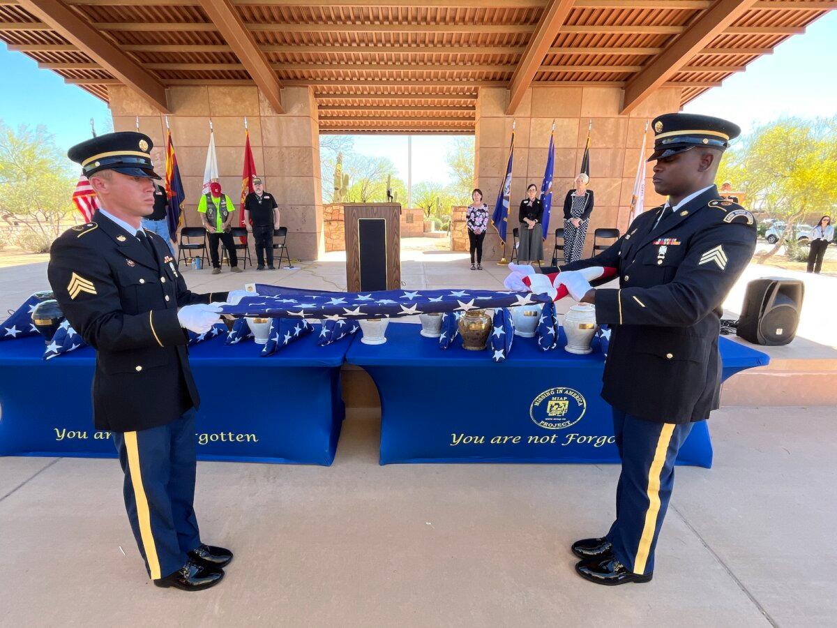 An Arizona Army National Guard Honor Guard conducts a flag unfolding ceremony at the National Memorial Cemetery of Arizona in Phoenix on March 18, 2026. (Allan Stein/The Epoch Times)