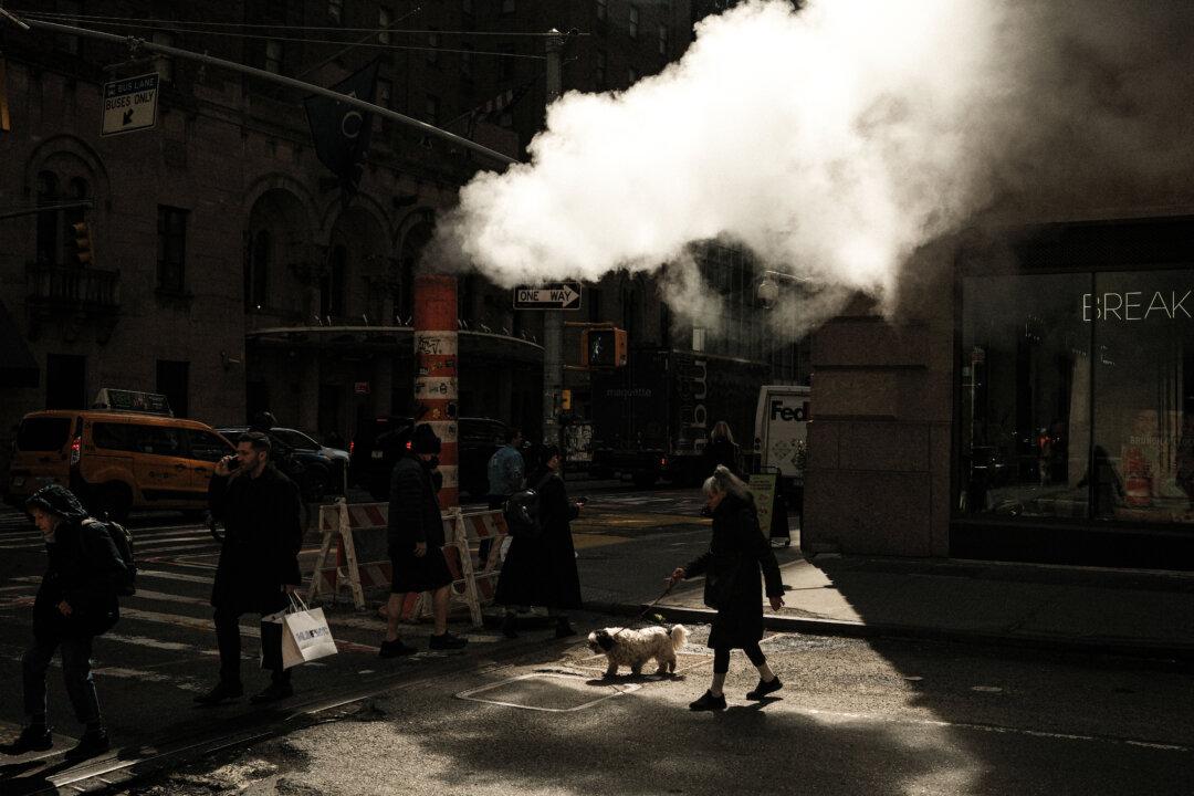 Steam rises as people walk along Lexington Avenue in the Manhattan borough of New York City on March 20, 2026. (Photo by CHARLY TRIBALLEAU / AFP via Getty Images)