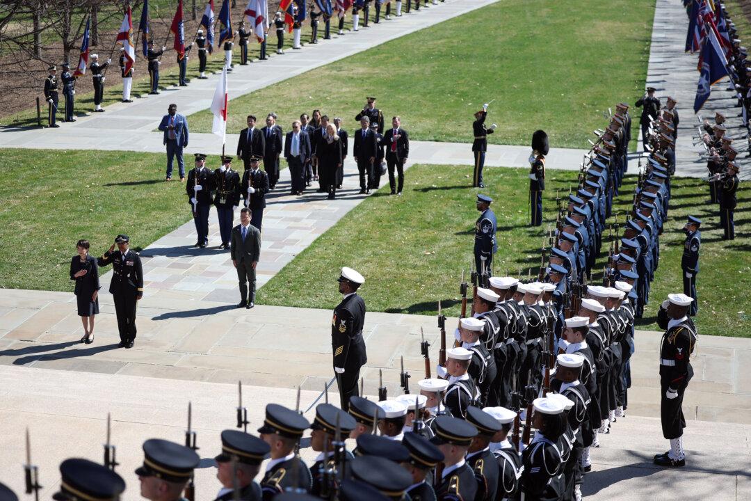 ARLINGTON, VIRGINIA - MARCH 20: Prime Minister of Japan Sanae Takaichi, joined by Army Maj. Gen. Antoinette Gant, stand for the U.S. and Japan national anthems as she arrives to lay a wreath at the Tomb of the Unknown Soldier at Arlington National Cemetery on March 20, 2026 in Arlington, Virginia. Takaichi is on an official visit to the United States, which included a meeting with President Donald Trump, where the two leaders discussed the conflict in Iran as well as security and economic cooperation between the two countries. (Photo by Kevin Dietsch/Getty Images)