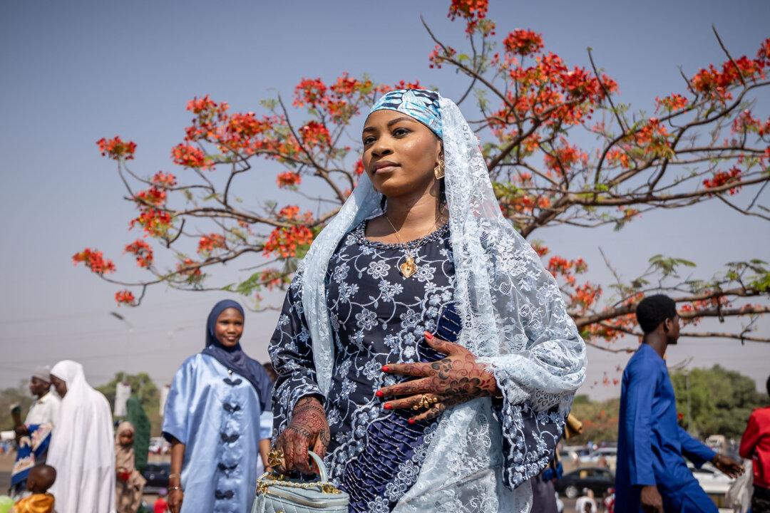 TOPSHOT - A Muslim devotee poses for a group photo after Eid al-Fitr prayers, marking the end of the holy month of Ramadan, at the National Eid prayer ground in Abuja on March 20, 2026. (Photo by Light Oriye Tamunotonye / AFP via Getty Images)