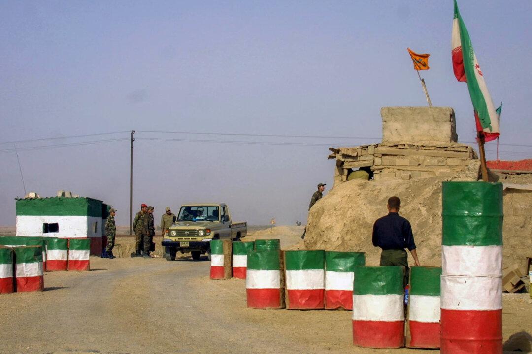 A car passes through an Iranian Revolutionary Guard checkpoint on the road between Ahvaz and Khorramshahr, Iran, on April 4, 2003. (Henghameh Fahimi/AFP via Getty Images)