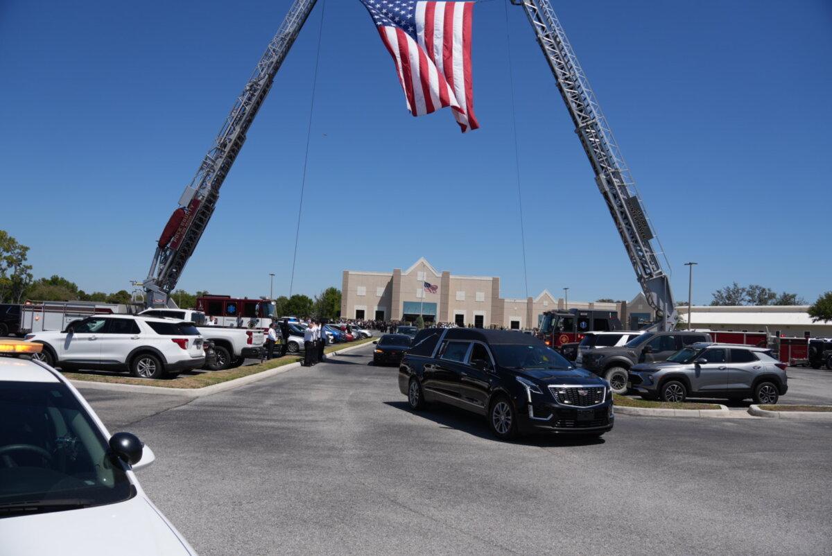 A hearse carrying the remains of Maj. Cody Khork, who was killed in the Iran war, departs the Haven Worship Center. Hundreds of people attended a memorial service for him in Winter Haven, Fla., on March 21, 2026. (Troy Myers/The Epoch Times)