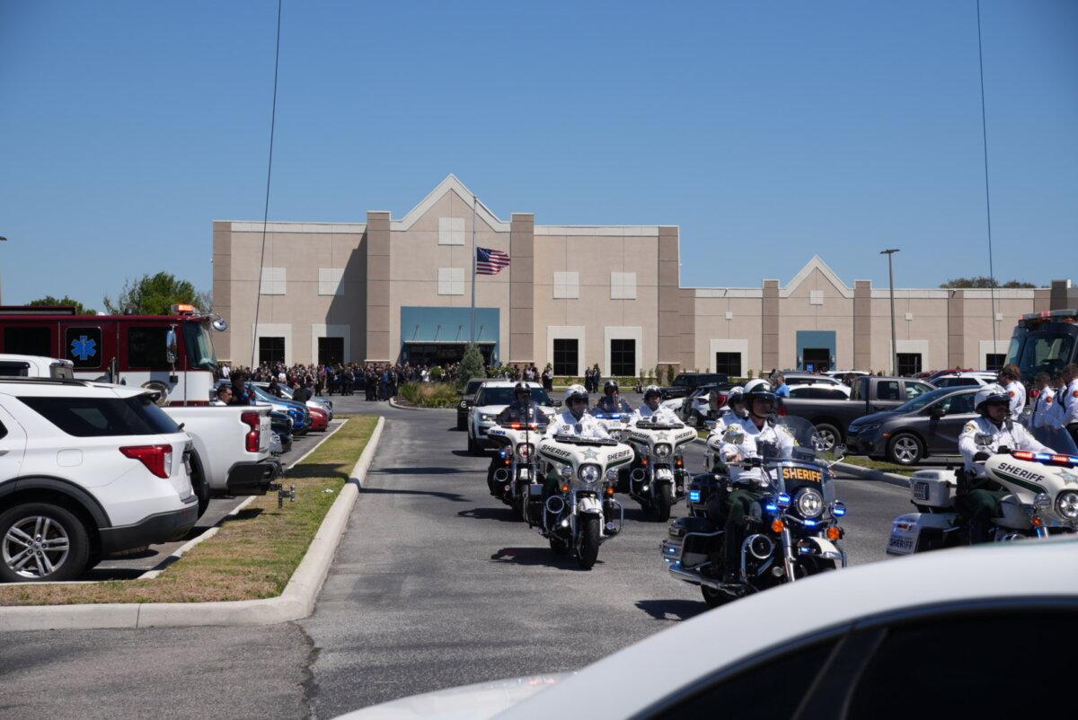 A motorcade departs the Haven Worship Center to escort the remains of Maj. Cody Khork, one of the soldiers killed in the Iran war. A memorial service was held for Khork in Winter Haven, Fla., on March 21, 2026. (Troy Myers/The Epoch Times)