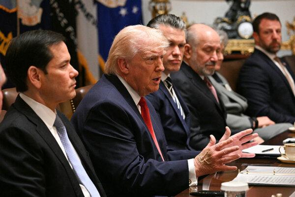 U.S. President Donald Trump, flanked by Secretary of State Marco Rubio (L), Defense Secretary Pete Hegseth (4th R), Commerce Secretary Howard Lutnick (3rd R), White House chief of staff Susie Wiles (2nd R) and Homeland Security Secretary Markwayne Mullin (R), speaks during a Cabinet meeting in the Cabinet Room of the White House in Washington on March 26, 2026. (Jim Watson/ AFP via Getty Images)