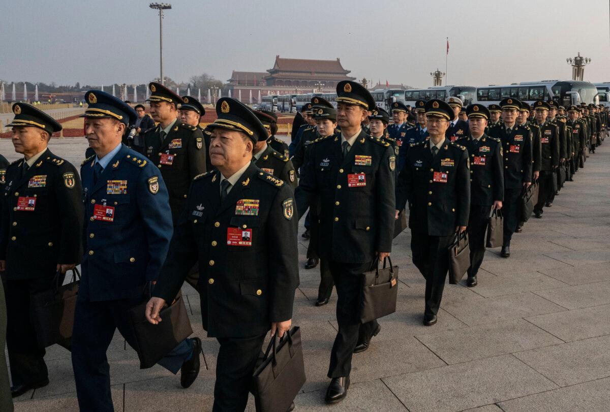 Chinese military deputies arrive at the second plenary session of the National Peoples Congress (NPC) at the Great Hall of the People, in Beijing on March 8, 2025. (Kevin Frayer/Getty Images)