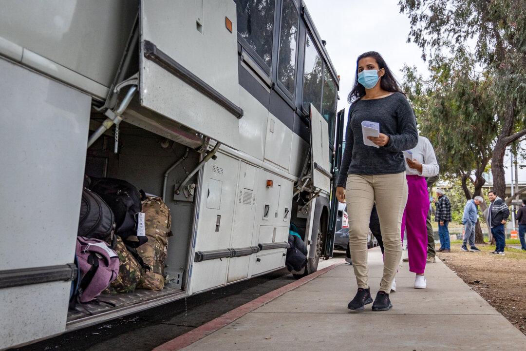 Buses drop off large groups of illegal immigrants in San Ysidro, Calif., on Feb. 29, 2024. The Supreme Court is set to consider a case challenging President Donald Trump’s effort to limit birthright citizenship for children of illegal immigrants born in the United States. (John Fredricks/The Epoch Times)
