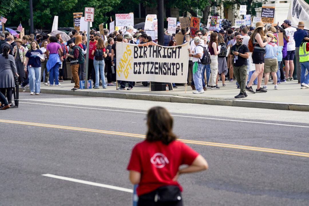 People protest outside the U.S. Supreme Court in Washington on May 15, 2025. Justices are hearing oral arguments over Trump’s effort to broadly enforce an executive order restricting automatic birthright citizenship. (Nathan Howard/File Photo/Reuters)