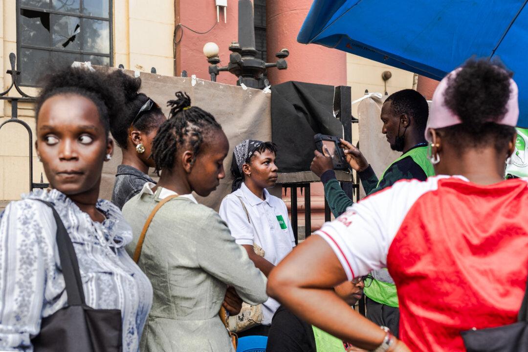 A young woman has her biometrics captured in a makeshift setup by officials using a biometric voter registrations kit (BVR) at a pop-up registration center for new voters during a mass voter registration drive by the national election regulator, Independent Electoral Boundaries Commission (IEBC) in the Kenyan capital Nairobi on March 30, 2026. (Tony Karumba / AFP via Getty Images)