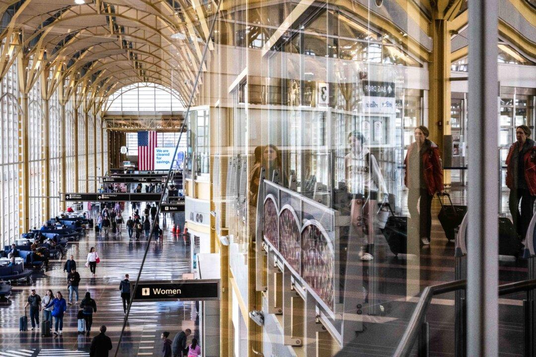 Travelers walk on the main concourse of Terminal 2 at Ronald Reagan International Airport in Washington on March 30, 2026. Airports around the country started recovering from long lines as TSA Agents begin to receive their first paychecks after about 61,000 TSA employees had been working without pay since a partial government shutdown started February 14. (Roberto Schmidt/Getty Images)