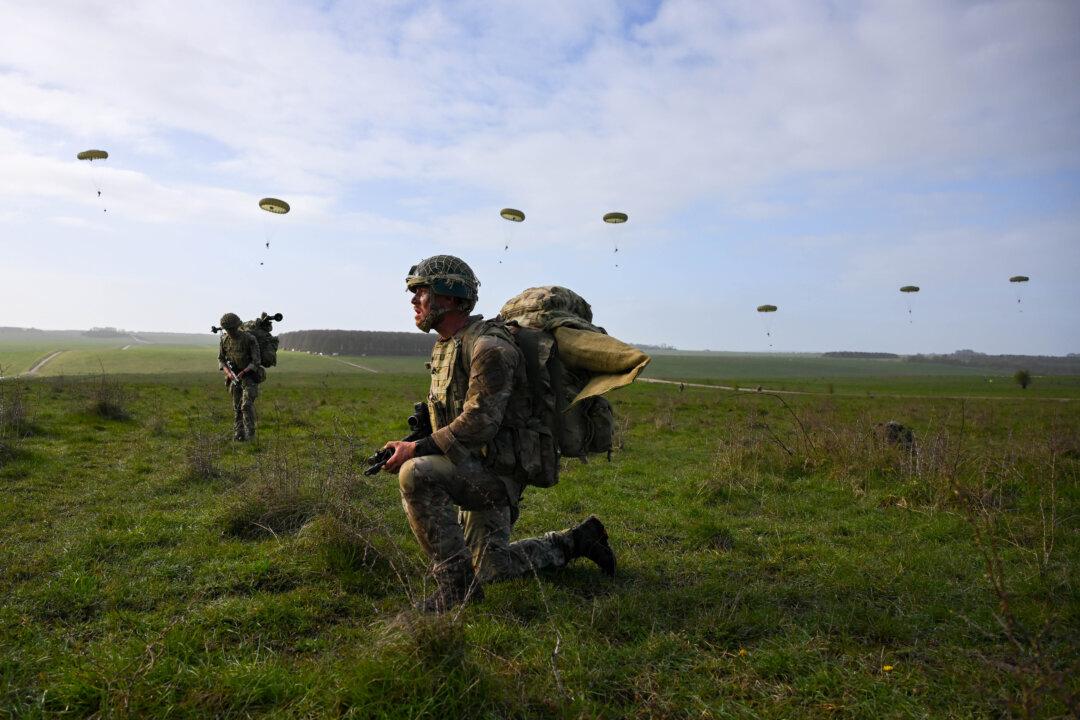 Soldiers from 16 Air Assault Brigade jump from a Royal Air Force A400M transport aircraft onto Salisbury Plain at Copehill Down training facility near Warminster, England, on March 30, 2026. Around 270 soldiers from 16 Air Assault Brigade are carrying out a "deter by denial" parachuting exercise as part of Joint Airborne Task Force (JATF) training. (Finnbarr Webster/Getty Images)
