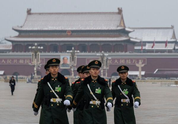 Members of the People's Armed Police march in front of a portrait of Chinese leader Mao Zedong at Tiananmen Square in Beijing on March 5, 2026. (Kevin Frayer/Getty Images)