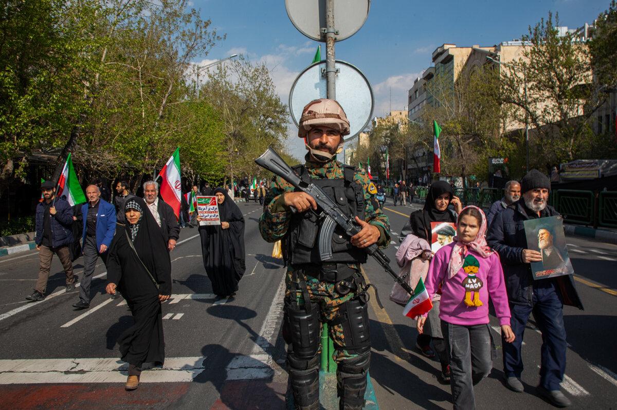 A member of the Iranian security services stands guard during a funeral procession for Iranian navy chief Alireza Tangsiri, alongside other senior naval commanders and their families who were killed in late March in U.S.–Israeli strikes, in Tehran, Iran, on April 1, 2026. (Majid Saeedi/Getty Images)