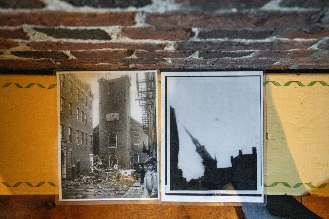 Photographs of Old North Church’s steeple collapse during Hurricane Carol on Aug. 31, 1954, are displayed in Boston on April 8, 2026. (Samira Bouaou/The Epoch Times)