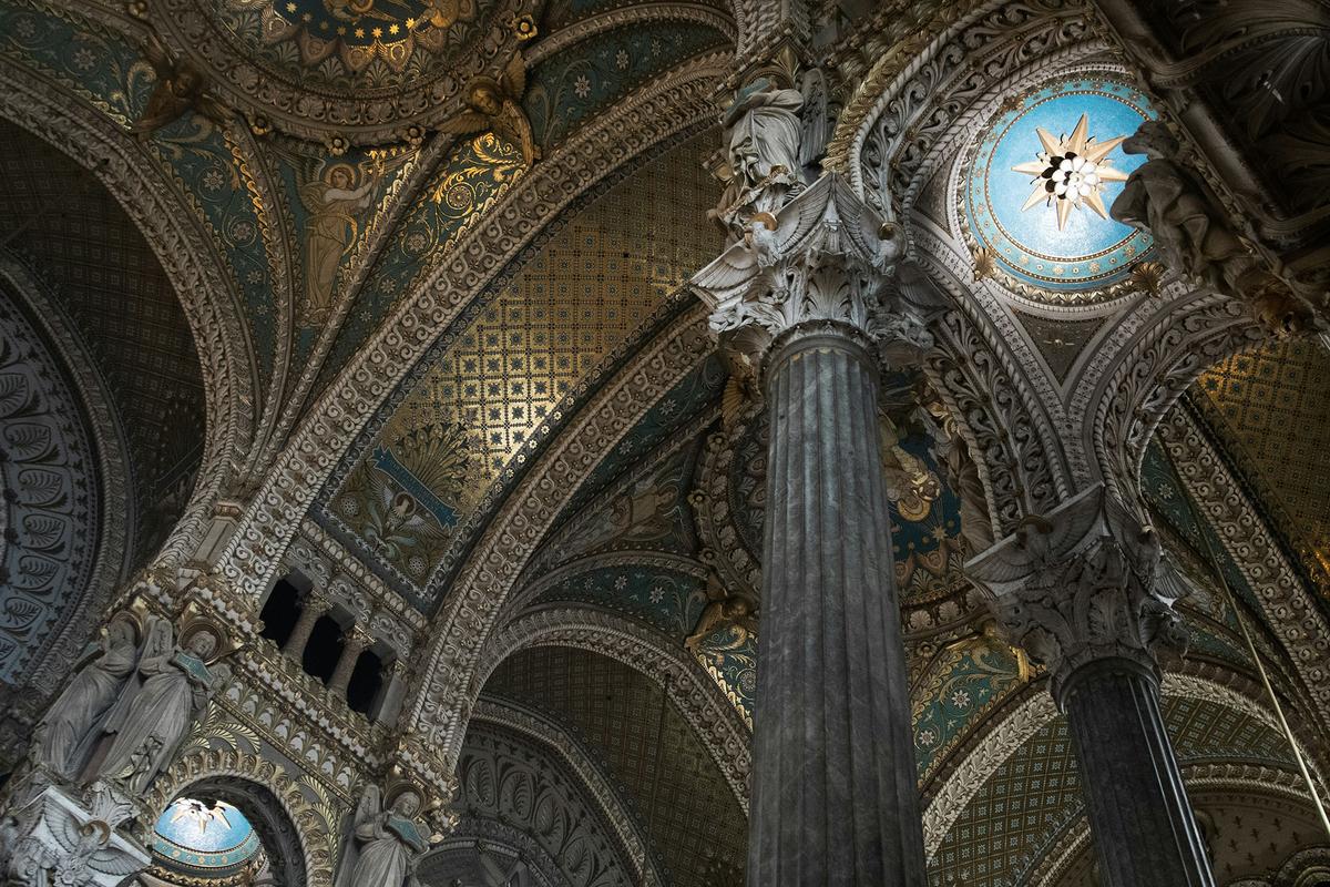 Inside the Basilica of Notre Dame, elaborate mosaics, stained glass, and decorative stonework draw the eye upward. (Ani Adigyozalyan/Unsplash)