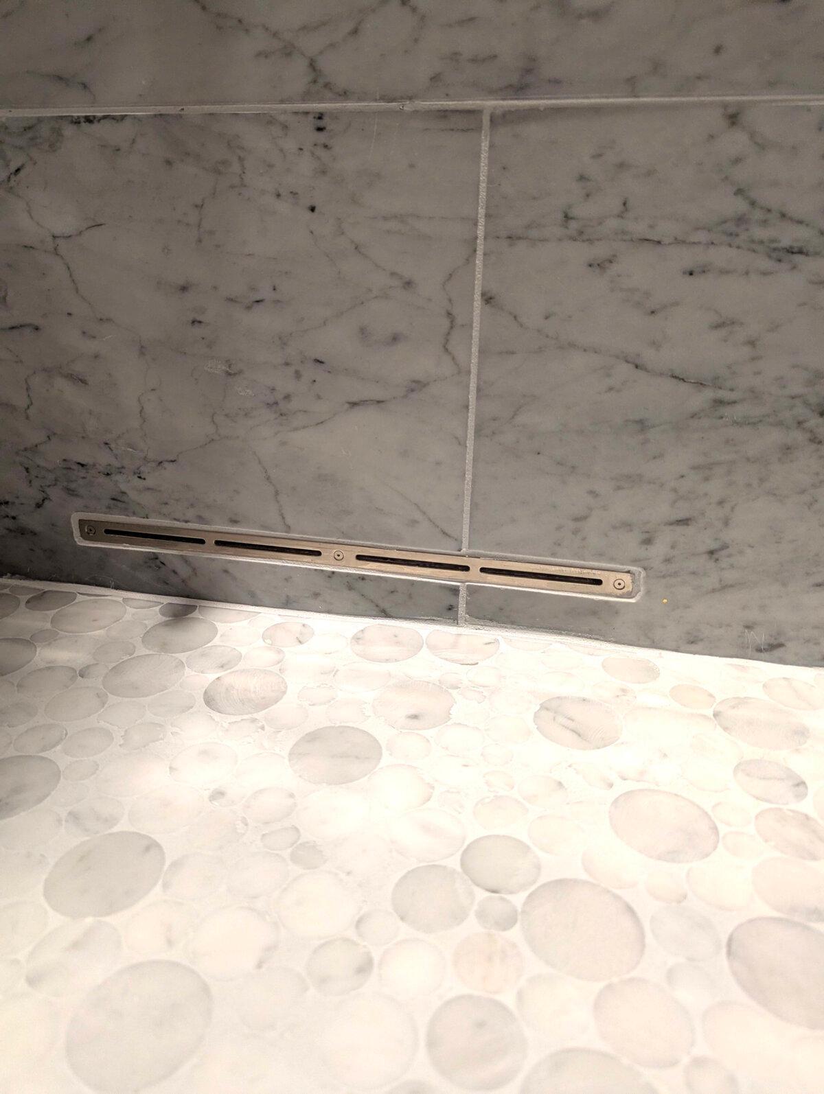 This narrow slot is connected to a high-speed fan that blows air into a shower. The air removes the water, stopping the growth of mold and mildew. (Tim Carter/Tribune Content Agency)