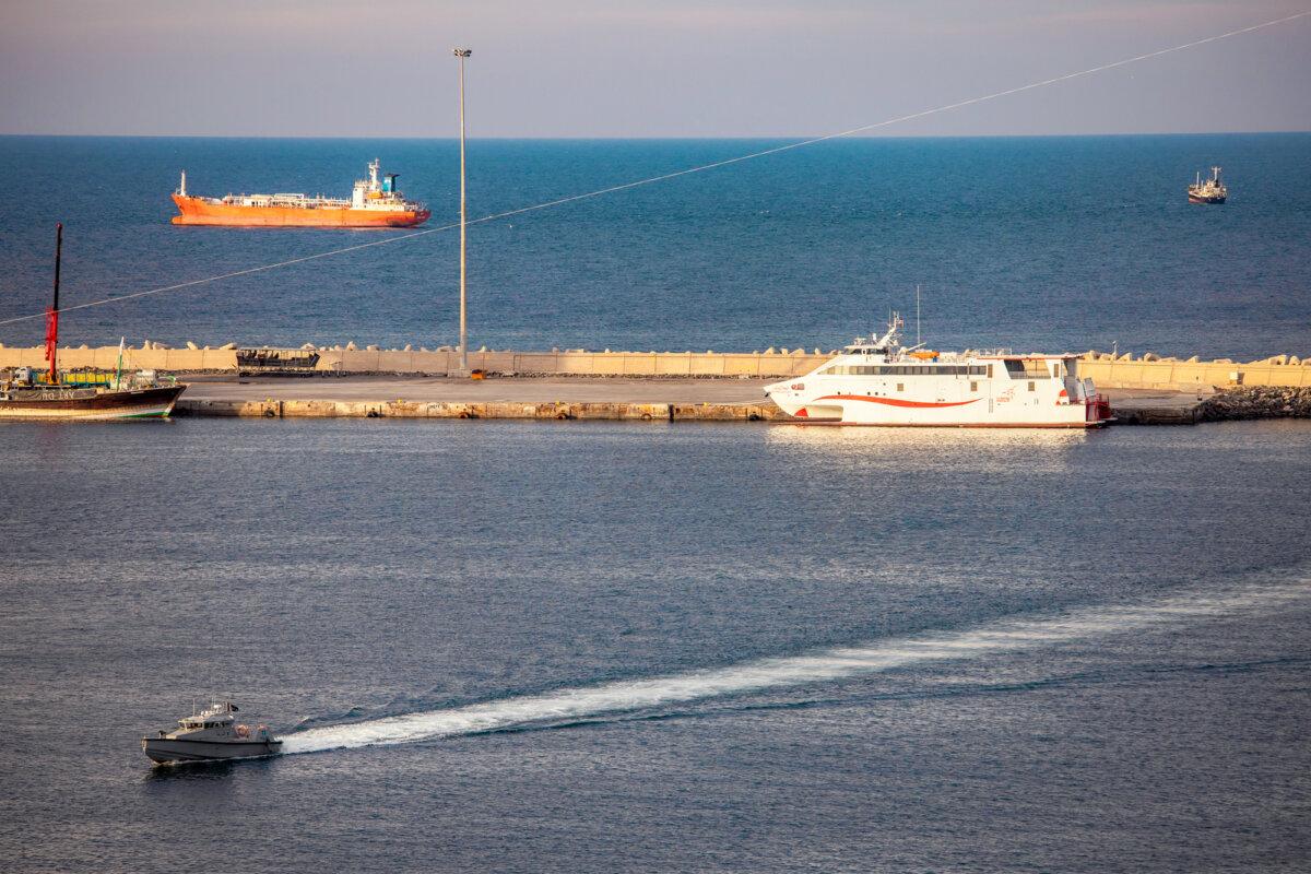 A police speedboat patrols the port as oil tankers and high-speed craft sit anchored near the Strait of Hormuz in Muscat, Oman, on March 30, 2026. (Elke Scholiers/Getty Images)