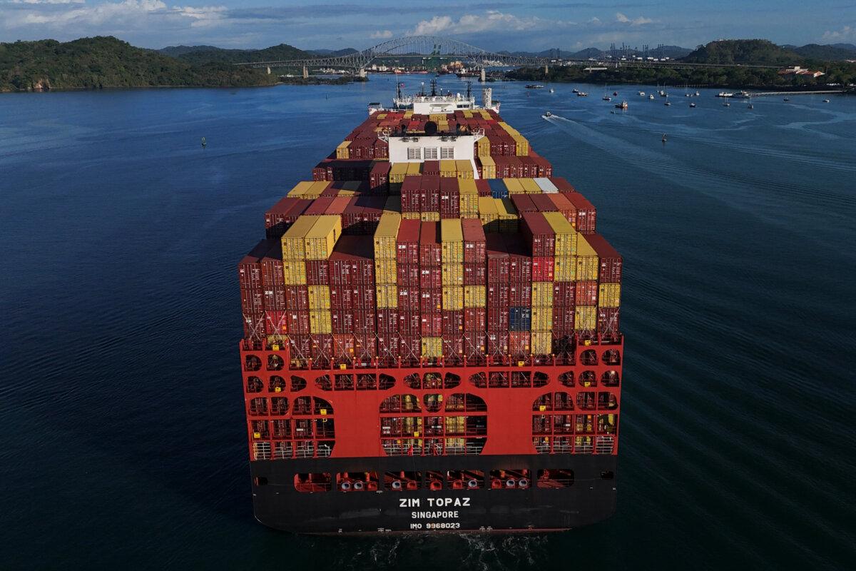 Cargo containers are stacked on a cargo ship moving through the Panama Canal, at sunrise in Panama City on March 25, 2026. (Matias Delacroix/AP Photo)