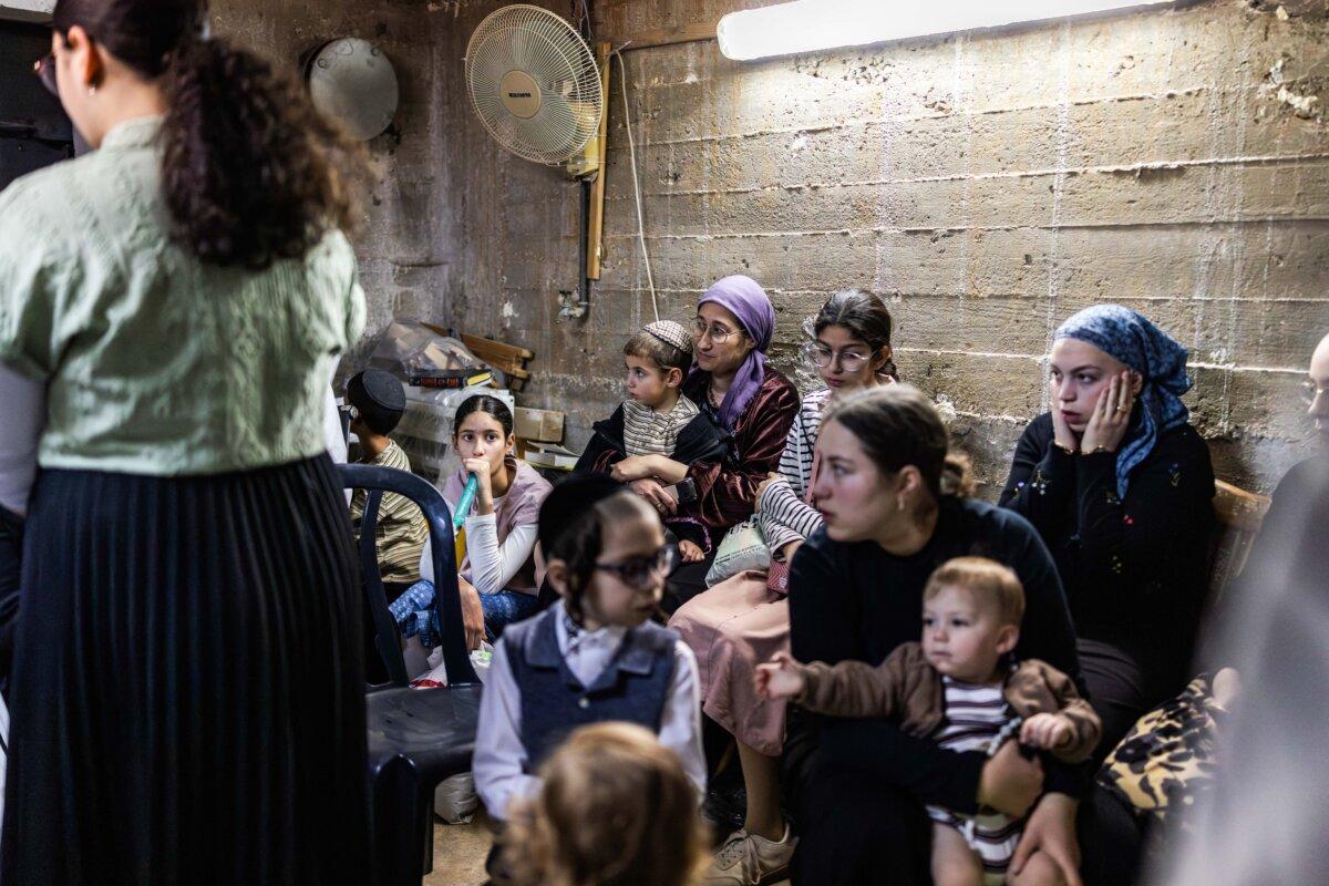 Ultra-Orthodox Jews take cover inside a bomb shelter in Bnei Brak in central Israel on April 6, 2026. (Ilia Yefimovich / AFP via Getty Images)